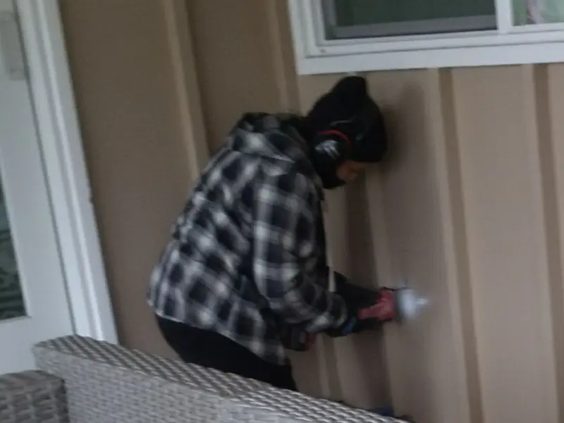 Professional electrician installing an exterior outlet in Clyde